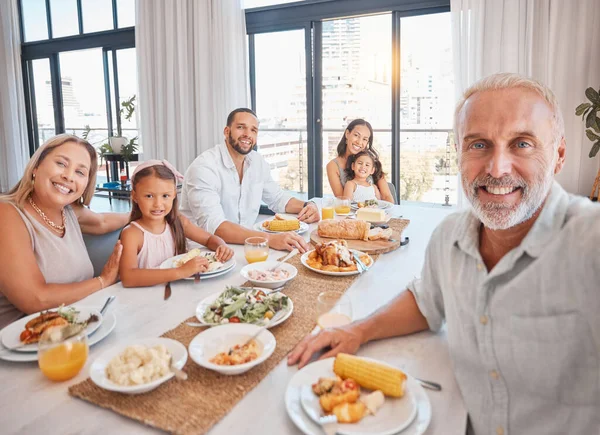 Big family, lunch selfie and food on table of dining room of modern apartment home for healthy meal, bonding love and celebrate event. Happy mother, father and children with grandparents eat together.