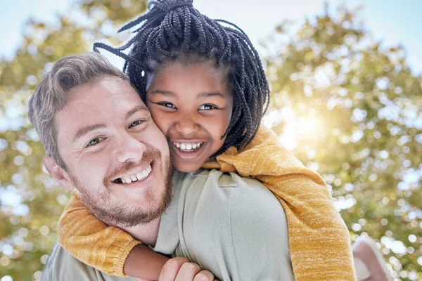 Portrait of father piggy back foster care girl in park for fun, bonding and quality time with love, care and happiness together. Adopted black kid relax with dad, diversity and happy family in garden.