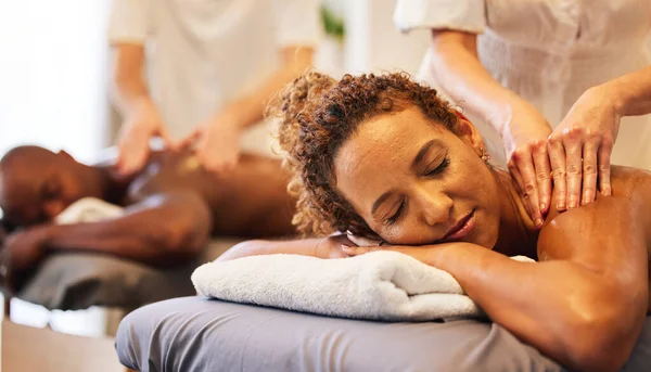 Black couple massage, spa and relax together on vacation, holiday or retreat for bonding, honeymoon or calm. Black woman, man or couple together for masssage therapy service, health and wellness.
