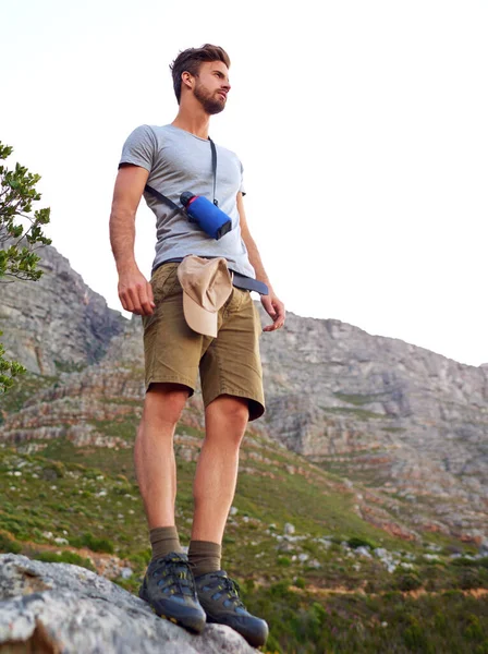 stock image Taking in the views. a handsome young man enjoying the view while hiking