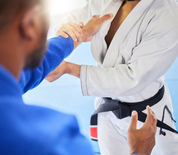 Man, closeup and karate training fight in gym, dojo and combat sport for exercise. Man, self defence and workout with black belt sensei at fitness club for body health, balance or martial arts sports.