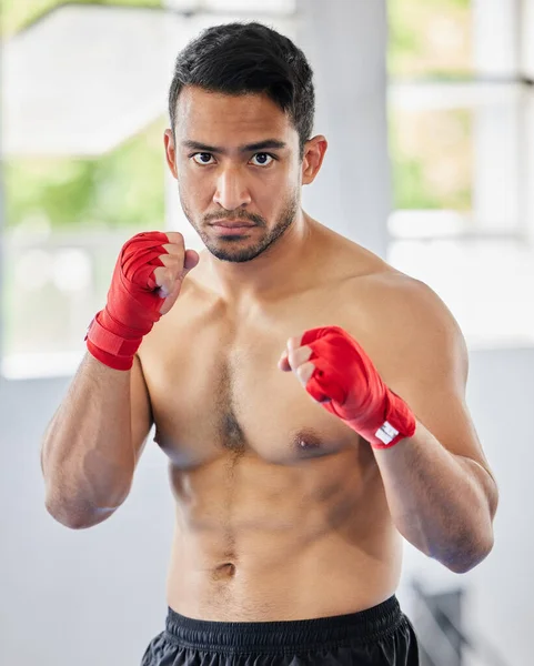 Fight, fist and kickboxing athlete man looking serious, angry and ready for martial arts exercise, training and competition. Asian sports or Muay thai model portrait for train session at ftness gym.