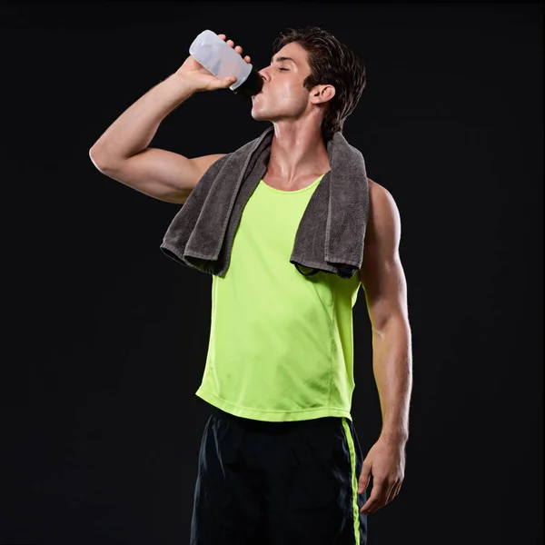 Stock image Time to refuel. Studio shot of a handsome young man in sportswear