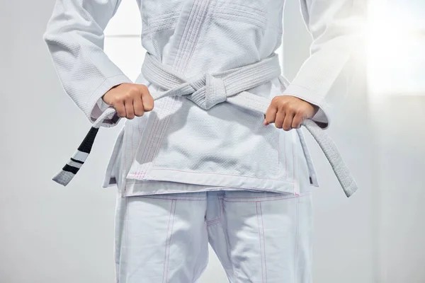 karate belt, martial arts and woman ready for fight battle, white dojo training or fitness challenge workout. Warrior motivation, taekwondo and hands of girl learning self defense for safety security.