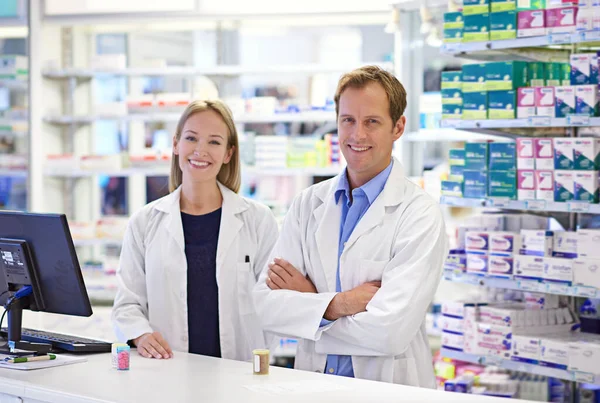 Were Here Our Customers Portrait Two Pharmacists Standing Prescription Counter — Stock Photo, Image