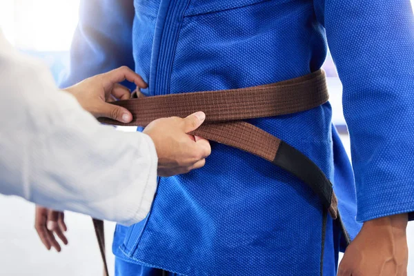 Karate brown belt, teacher and student fitness, taekwondo training, sports graduation and workout learning. Martial arts uniform, fighter and trainer getting ready in dojo gym, practice and exercise.