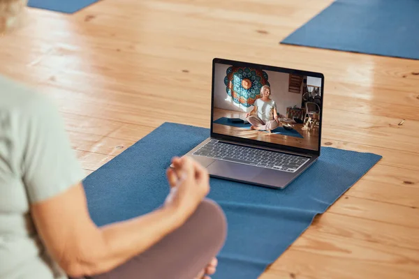 Yoga, laptop and woman doing video exercise for health, wellness and balance in zen studio. Calm, peace and healthy lady with meditation or pilates workout with online tutorial guidance with computer.