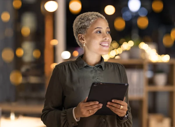 Night, tablet and business black woman in digital marketing for innovation planning, online strategy and internet research in bokeh office. Happy global manager with analytics report for tech company.