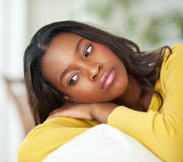 stock image Deep in thought. an attractive young woman looking pensive at home