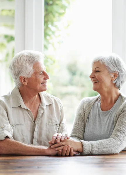 stock image Thank you for sharing this beautiful life with me...A loving senior couple holding hands as they sit at a table