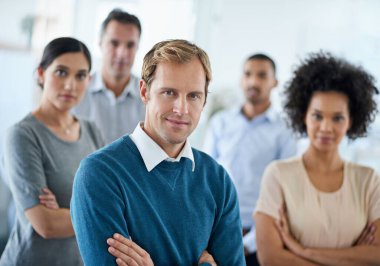 We set goals and achieve them. Portrait of a group of diverse colleagues standing in an office clipart