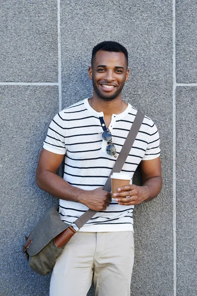 モダンなスタイルと幅広い笑顔 街の壁に寄りかかっているハンサムなアフリカ系アメリカ人ビジネスマン — ストック写真