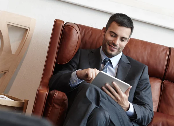 Impressed Its Features Smiling Young Businessman Sitting Leather Sofa While — Stock Photo, Image