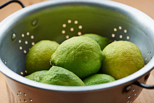 Cytryna Świeża Colander Wypełniony Zielonymi Cytrynami Stole Kuchennym — Zdjęcie stockowe