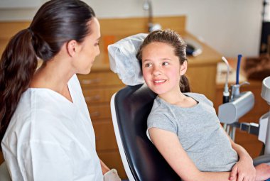 So what can I do for you today. a female dentist and her child patient clipart