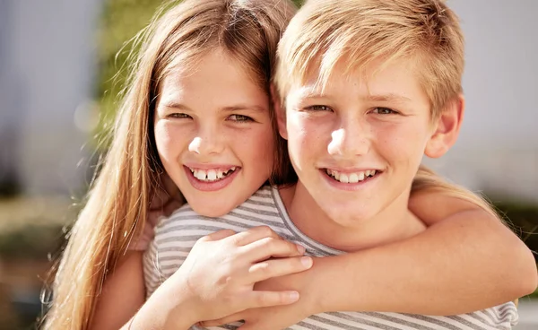 stock image Girl, boy and portrait in family, smile and happy siblings in home backyard, garden and hug together. Kids, brother and sister with love, bonding and care in summer sunshine, outdoor and happiness.