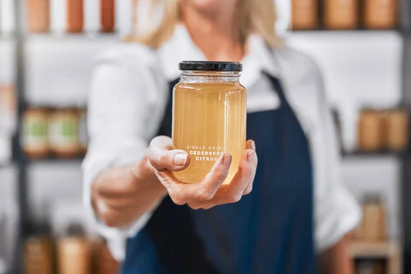 ガラス 蜂蜜と彼女の店で生 有機的で健康的な製品を提供する女性の中小企業の所有者の手 市場での地元のビジネス ビジネス女性と蜂蜜瓶 環境に優しく持続可能な — ストック写真