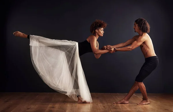 愛の物語の表現 暗い背景の前で劇的なポーズをとる女性と男性の現代ダンサー — ストック写真