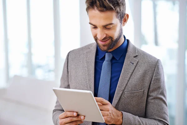 Super easy to use. Man in a contemporary suit holding a tablet