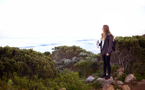 stock image The view is so beautiful from up here. an attractive young woman enjoying nature while out hiking