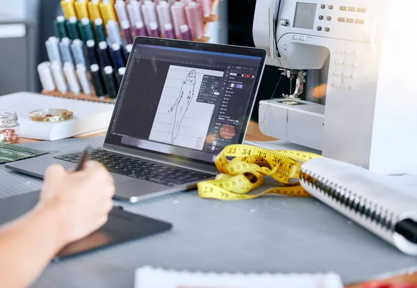 stock image Fashion, designer and laptop for a sketch or drawing for clothes manufacturing in a tailor workshop or factory for creative ideas. Hand of woman at desk with design technology for illustration work.