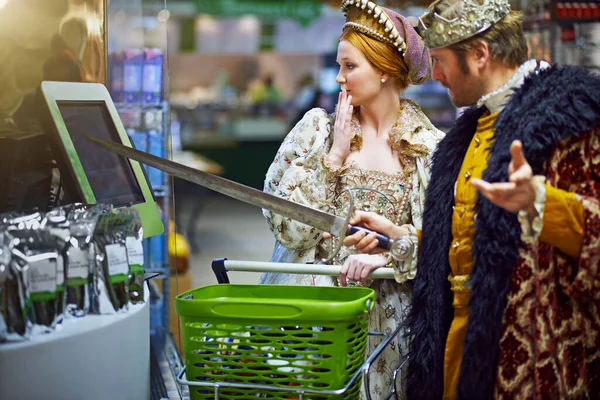 stock image En garde ye dastardly thing. a king and queen trying to use a touchscreen monitor while shopping in a modern grocery store