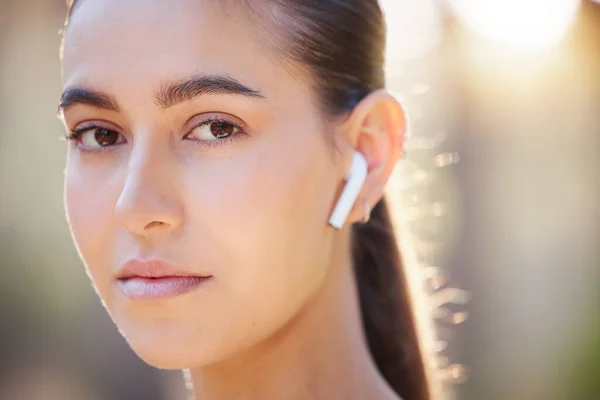 stock image Face portrait, earphones and woman in nature streaming music, radio or podcast. Sports, fitness and female from Canada outdoors listening to audio, song or sound track and getting ready for training