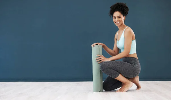 Yoga, portrait and black woman, mockup and fitness, healthy lifestyle or wellness marketing, advertising space and sports branding. Happy female workout, blank wall and exercise mat in pilates studio.