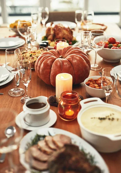 Thanksgiving, festival celebration and food on table ready to eat on holiday, vacation and traditional party. Festive, Christmas and delicious feast with pumpkin, turkey and meat on dinner table.