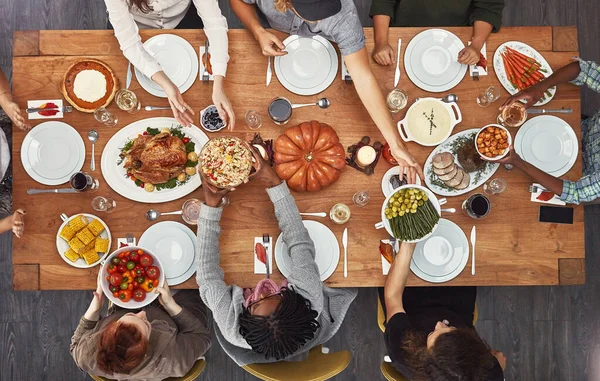 stock image Top view, holiday dinner and thanksgiving table in social home, house or restaurant with festive food. Above, dining room or friends group with diversity, celebration or lunch with happiness together.