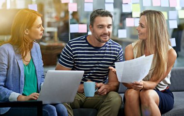 Can I get your thoughts. three business colleagues looking over some paperwork clipart