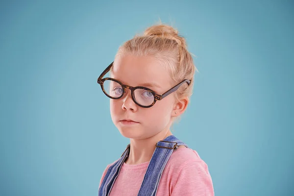 你竟敢嘲笑我的新眼镜工作室拍摄的一个蓝色背景戴嬉皮士眼镜的小女孩的照片 — 图库照片