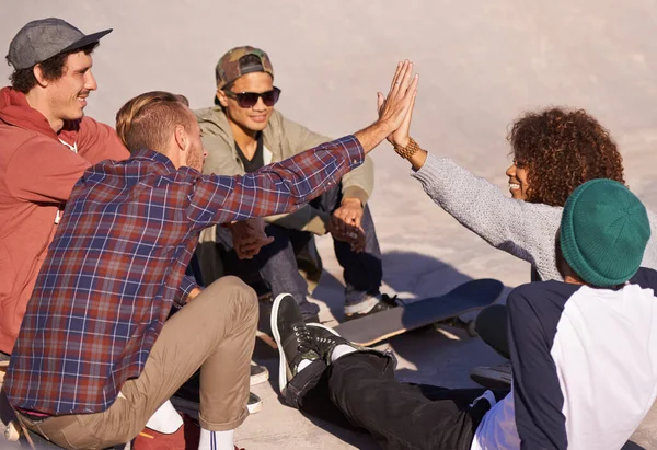去周末 一群朋友坐在一个溜冰场的阳光下 — 图库照片