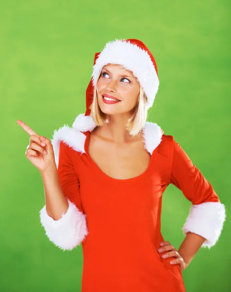 クリスマスの服 若い女性と笑顔で指して マーケティング スタジオの背景を持つための幸せと喜び クリスマス 女性や女の子の思考 幸福やモックアップや緑とお祝い — ストック写真