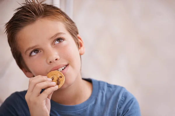 Delicious Young Boy Lost Thought While Biting Cookie — Stock Photo, Image