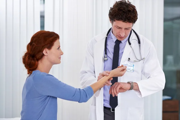 stock image Just give me one second. a doctor checking his patients pulse