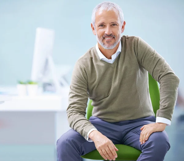 stock image He built up this company from scratch. Portrait of a mature businessman sitting on his office chair