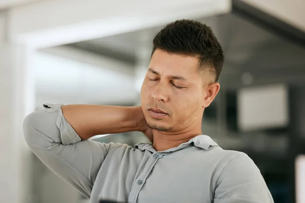 Neck pain, business man and burnout in office with stress, anxiety and discomfort while working late to meet deadline. Neck, ache and businessman suffering with shoulder, spine and headache at a job.