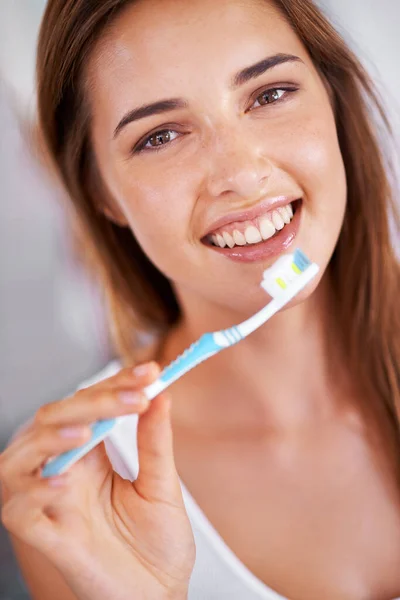 Stunning smile. a young, pretty girl brushing her teeth