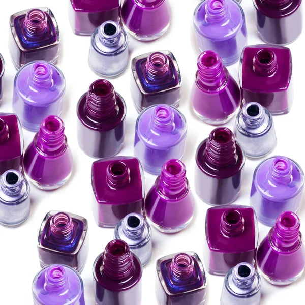 You can never have too much purple in your life. Studio shot or a variety of purple-hues nail varnish bottles