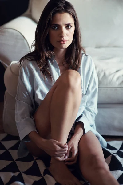 No pants, no stress. Portrait of a beautiful young woman sitting semi-nude on her floor at home
