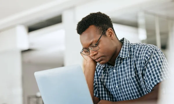 Burnout, depression and black man at work laptop with deadline, email and report at engineer workplace. Fatigue, tired and thinking engineering employee unhappy working at office with problem
