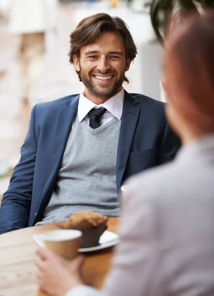 A casual business meeting. A businessman and woman having a meeting over coffee