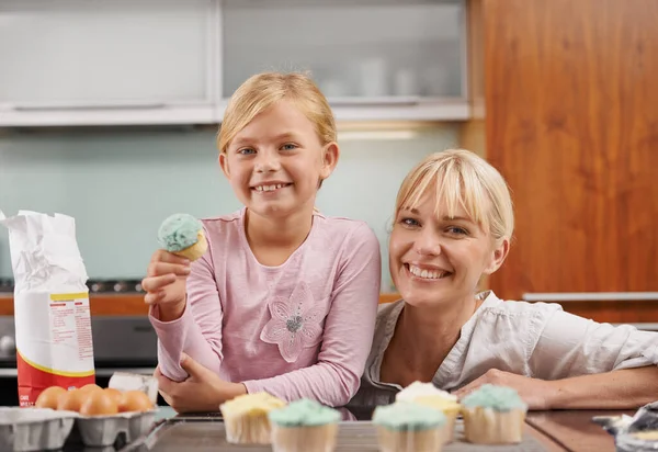 Baking together. an attractive young woman baking with her adorable daughter