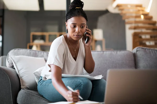 Woman, call and laptop budget planning conversation with online financial consultant to help with taxes on living room sofa. Black woman, work from home and remote internet fintech banking consulting.