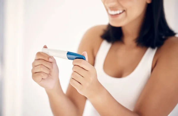 Good news, smile and woman with pregnancy test in bathroom happy, excited and celebrate positive results. Fertility, love and pregnant woman ready for motherhood and future children, family and baby.
