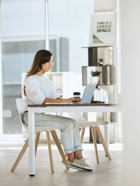 Woman, working and laptop at digital marketing company, eco startup and work with technology at desk. Green business, seo content writing and online research for blog post or social media advertising.