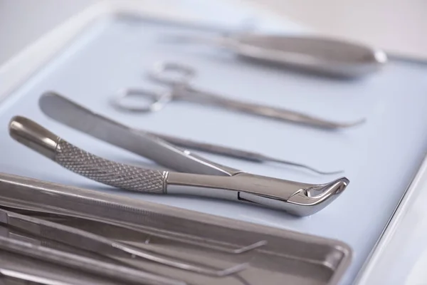 The tools of the trade. Closeup view of dental surgical instruments lying in a row