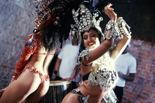 Live performances are her passion. two beautiful samba dancers and their band