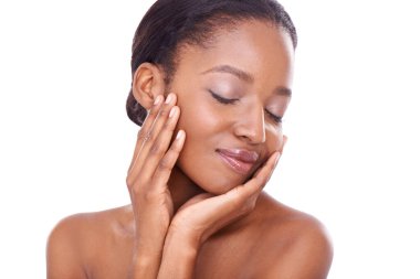 Soft to the touch. Beauty portrait of a young african woman touching her skin clipart